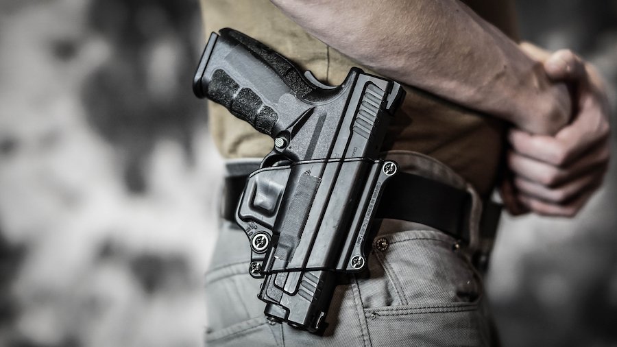 Man openly carrying a pistol on his belt.