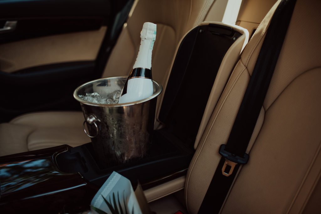 Unopened wine bottle in center console of car
