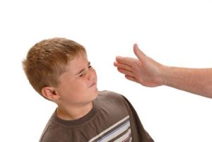 Woman slapping little boy