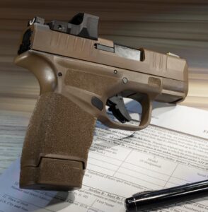 Pistol on table with registration paperwork