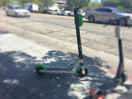 Electric scooter parked on the sidewalk