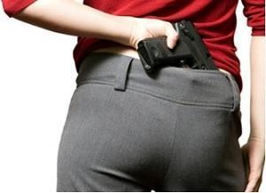person placing gun in rear waistband 