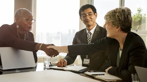 Job applicant shaking hands with person interviewing her