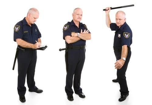 a policeman writing up a ticket, looking menacing, and holding a baton
