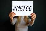 Woman holding 'me too' sign