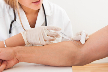 Technician takes a blood sample from a DUI arrestee