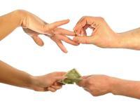 hands exchanging rings for money (alimony waivers)