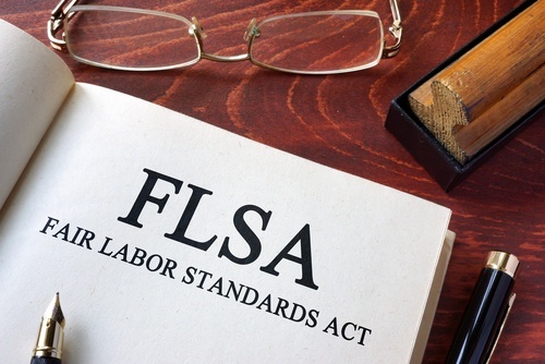 Book with page that reads FLSA - Fair Labor Standards Act