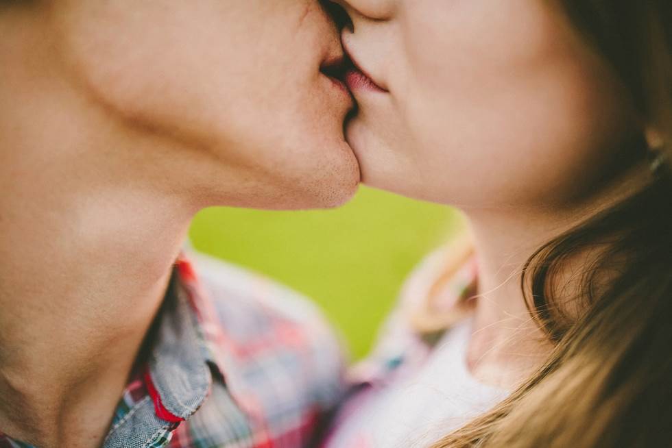 A man and a woman kissing.