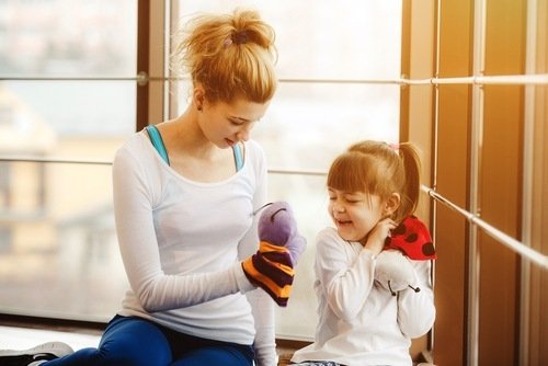 woman watching small child in gym