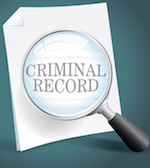 Magnifying glass over paper with the text criminal record.
