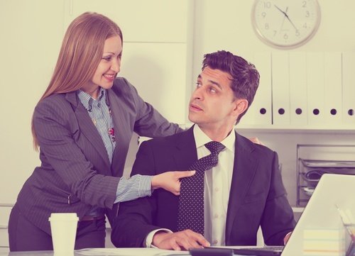 Woman sexually harassing man in workplace