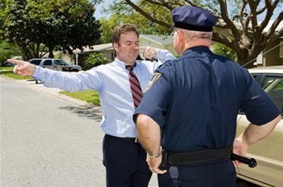 police officer administering the finger-to-nose test as part of a roadside DUI investigation