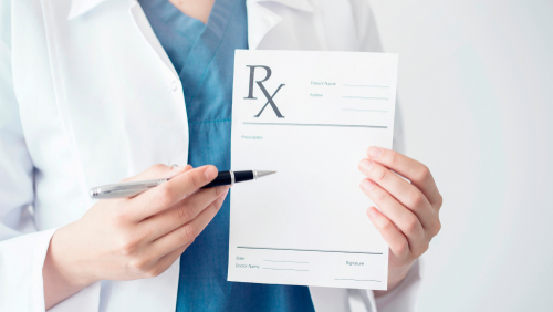 doctor holding a prescription pad and a pen