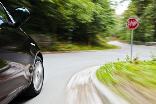 Car speeding by stop sign