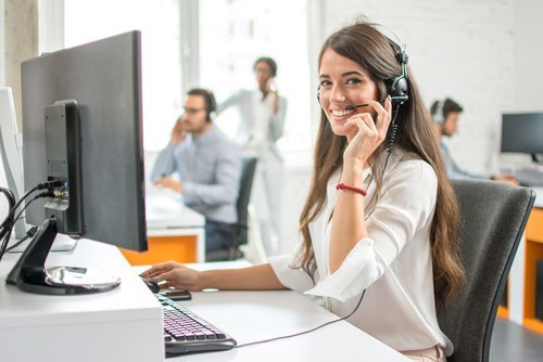 receptionist at computer station with headset