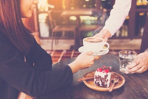 brazos de un camarero sirviendo pastel, café y agua a una joven - las pérdidas salariales en un caso de lesión personal en Nevada pueden incluir propinas y bonificaciones