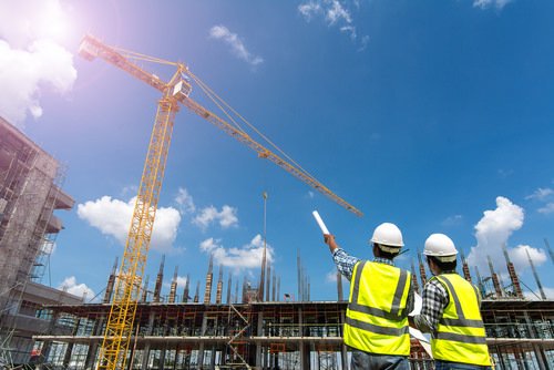 Workers at construction site observing a crane - independent contracts are not covered under workers' compensation in Nevada