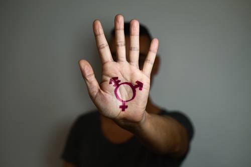 Hand reached out with transgender symbol