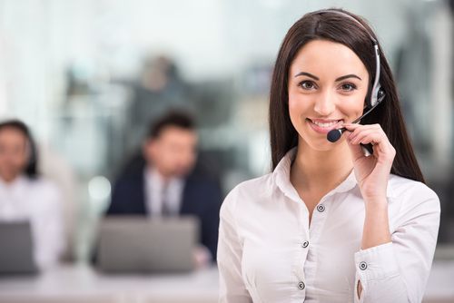 Receptionist smiling and wearing a headset