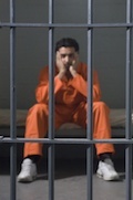 inmate behind jail bars