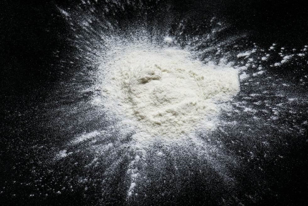 pile of white powder on a dark surface