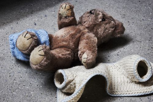 teddy bear on the floor with a sad face