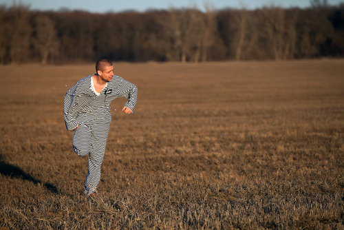 escaped prisoner running through a field