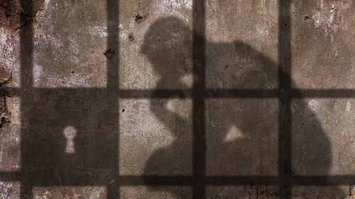 shadow of an inmate in a jail cell