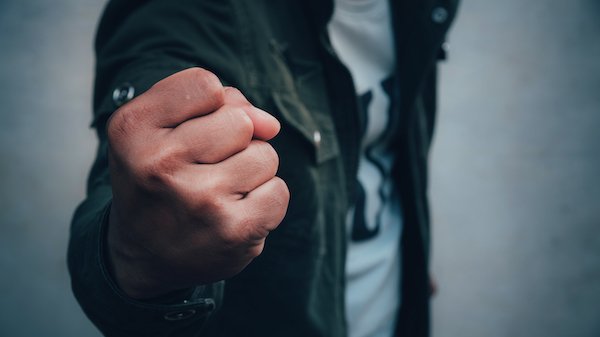 A person holding a fist about to punch