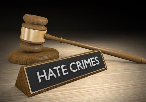 hate crime written on name sign, and a gavel behind it