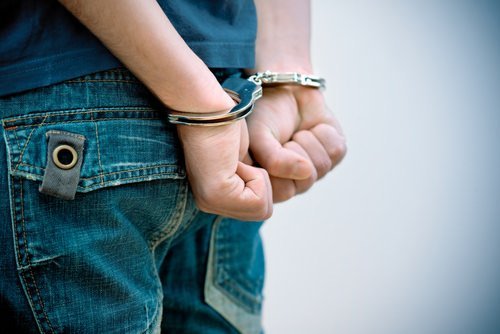 Closeup of child's hands in cuffs