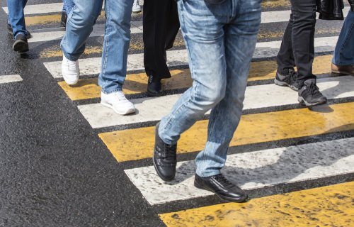 pedestrians crossing the street in a crosswalk