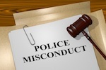Paper that says "police misconduct" with gavel to the side