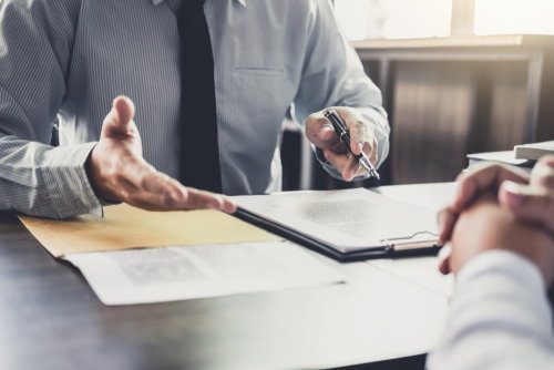 Attorney at desk meeting with a client