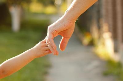 parent and child touching hands