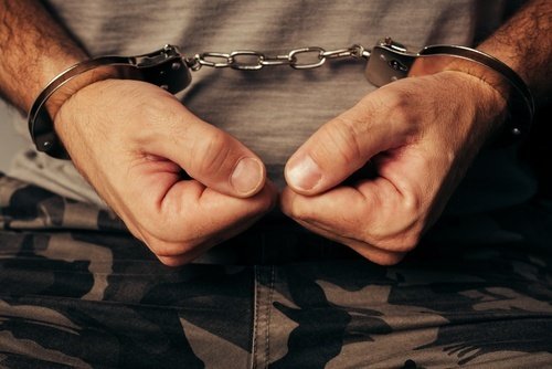 Veteran in camouflage in handcuffs after being arrested