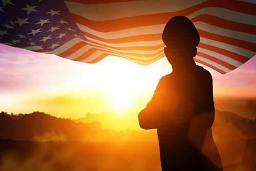 veteran soldier standing in the sun next to flag - Penal Code 1170.9 allows for treatment in lieu of jail in certain criminal cases