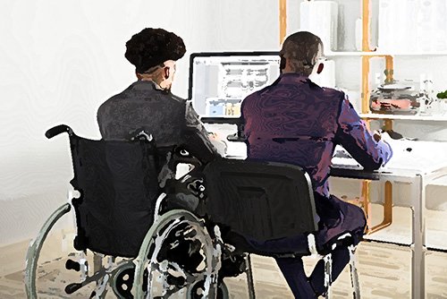 man in wheelchair sitting behind computer as an example of light duty in a worker's compensation case