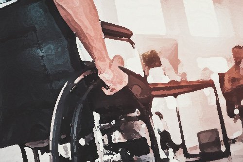 hombre en silla de ruedas en oficina