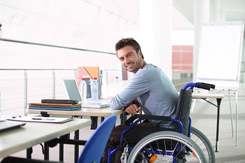 man in wheelchair at work station