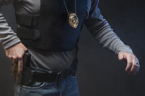 A police officer pulling his gun out of his holster