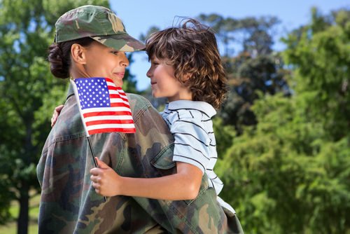 soldier in uniform holding a child