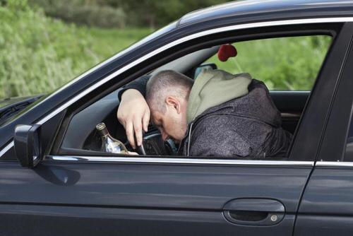 man slouched on steering wheel drunk dui