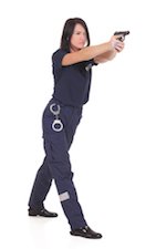 female law enforcement officer aiming her gun