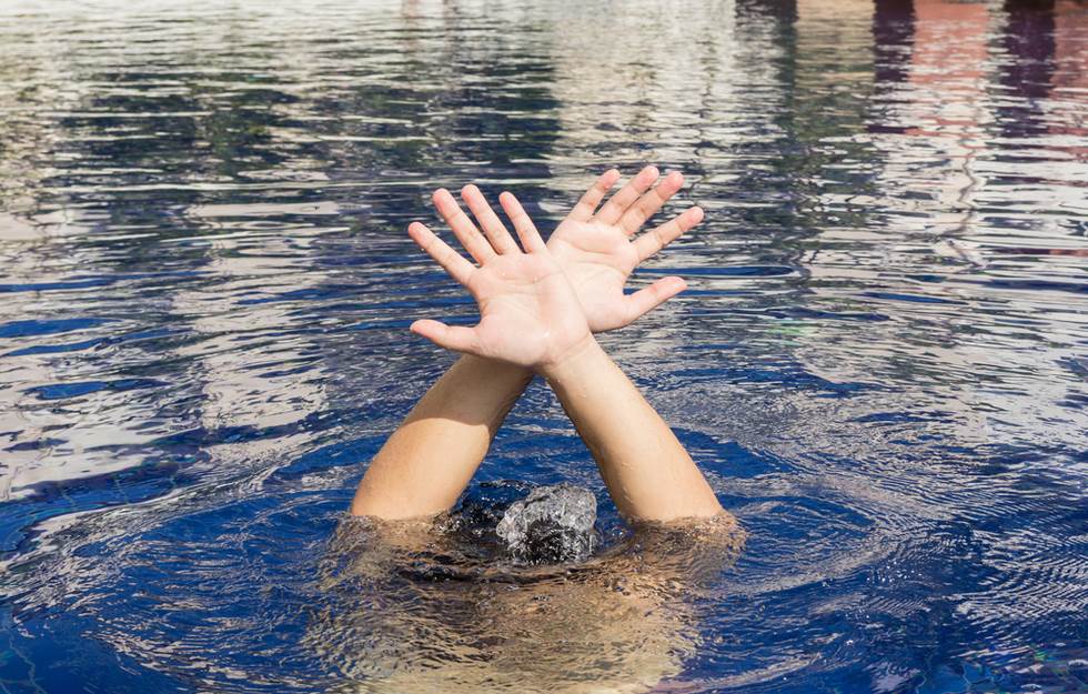 boy under water with hands breaking the surface