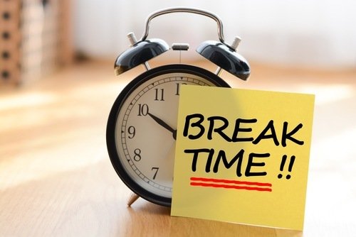 Alarm clock with post-it note that reads "Break Time"