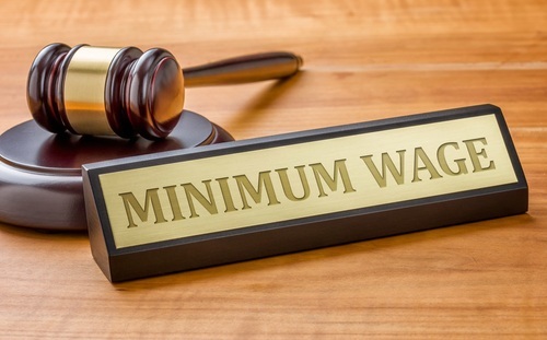 placard that says 'minimum pay' and gavel