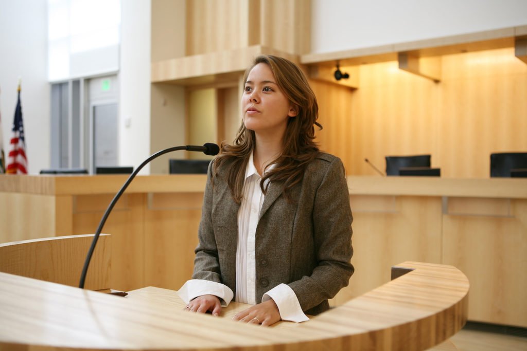Woman on witness stand about to commit perjury
