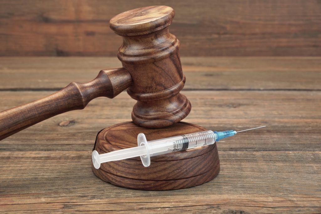 Gavel with lethal injection syringe. 